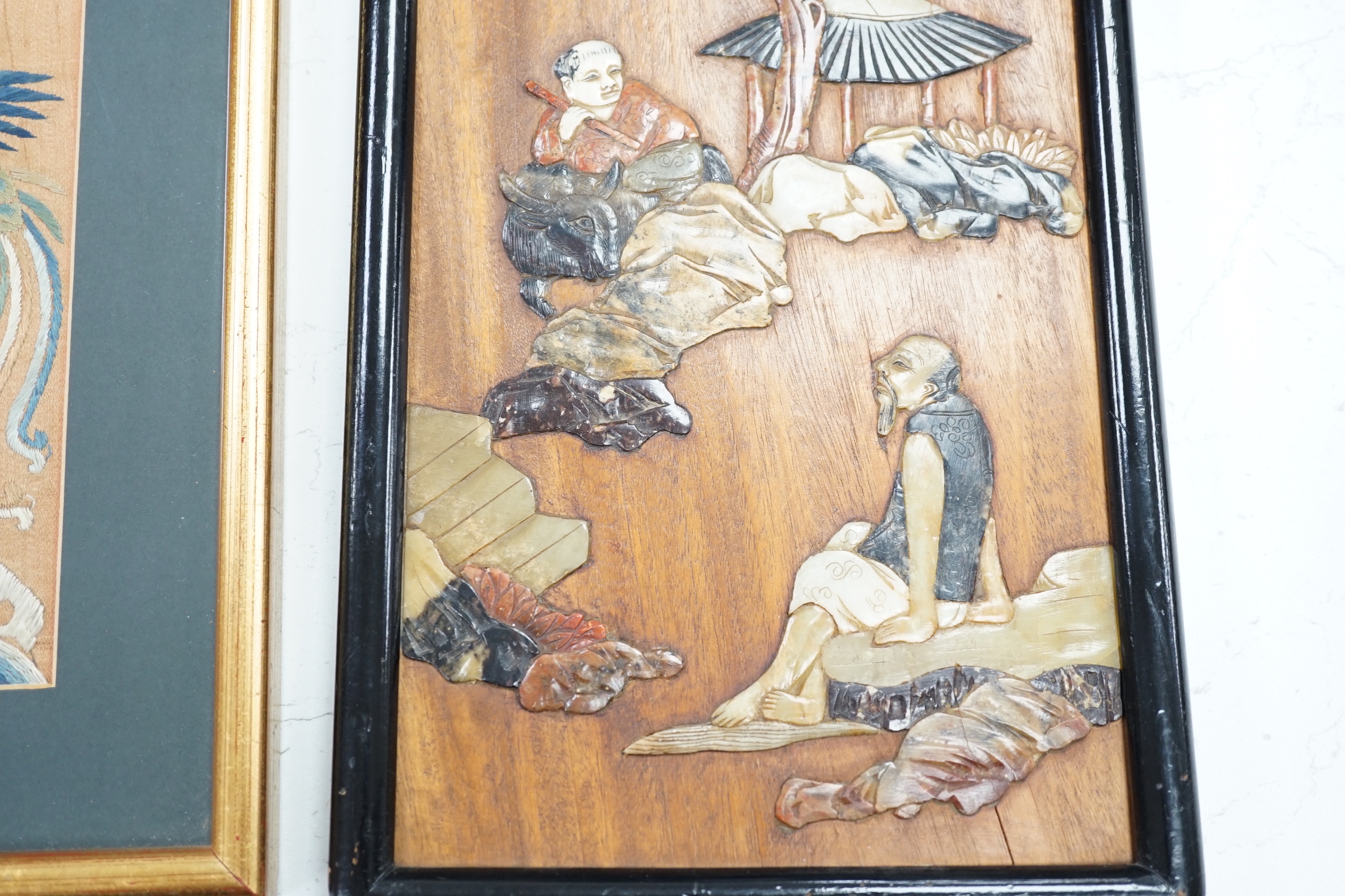 Two Chinese hardwood and mixed soapstone panels and a silk embroidered panel, largest 14.5cm x 29.5cm high